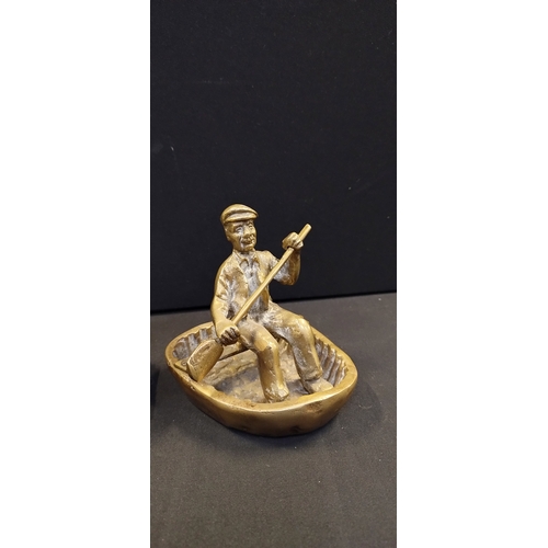 268 - Vintage brass St George and dragon door stop and a Solid Brass Gold Man in a Welsh Coracle Rowboat