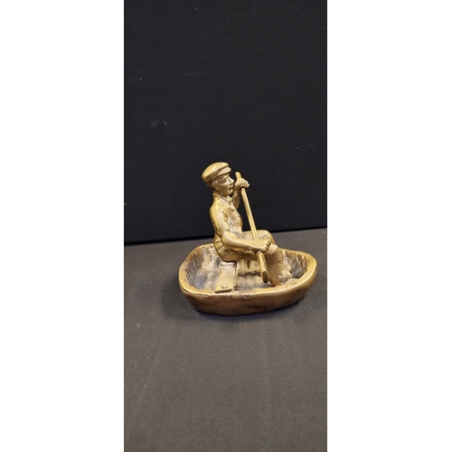 268 - Vintage brass St George and dragon door stop and a Solid Brass Gold Man in a Welsh Coracle Rowboat