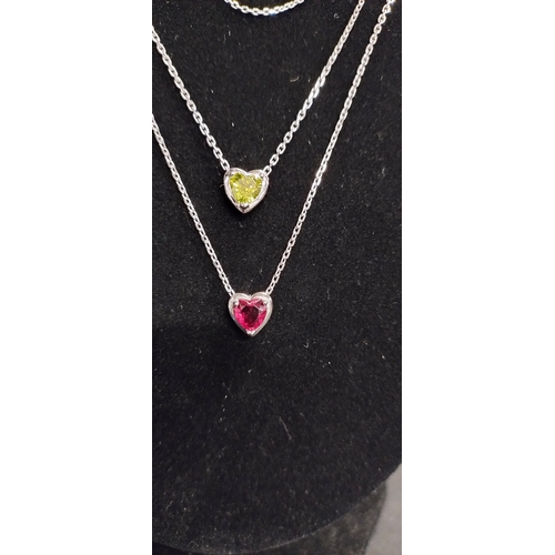 358 - Three necklaces one plain, two with a heart pendant with red and green glass central stone