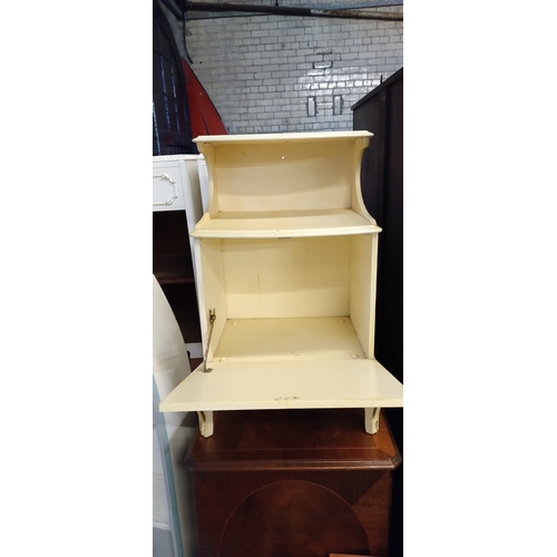 419 - Vintage side table with drop down cupboard and shelf in cream