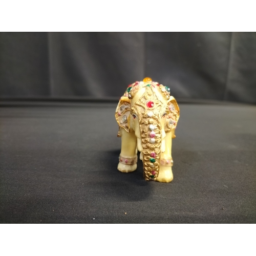 56 - Kaolinite Buddha and decorated resin elephant