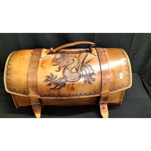 58 - Tan leather saddle bag with handle and buckle fastening.  dragon and scallop edging decoration measu... 