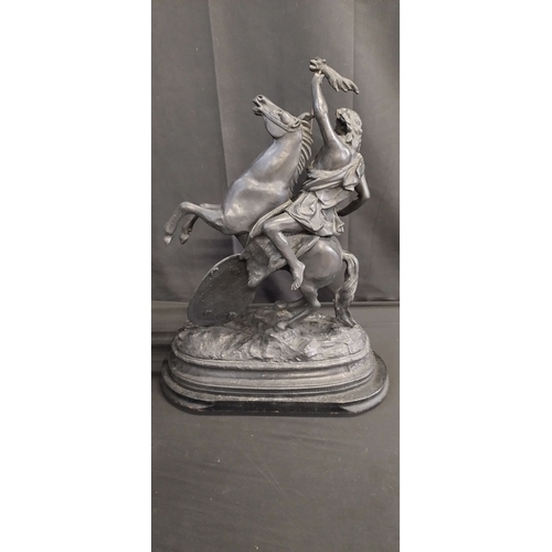 64 - Theodore Doriot spelter sculpture of a warrior on horseback mounted on a wooden base. Measures appro... 