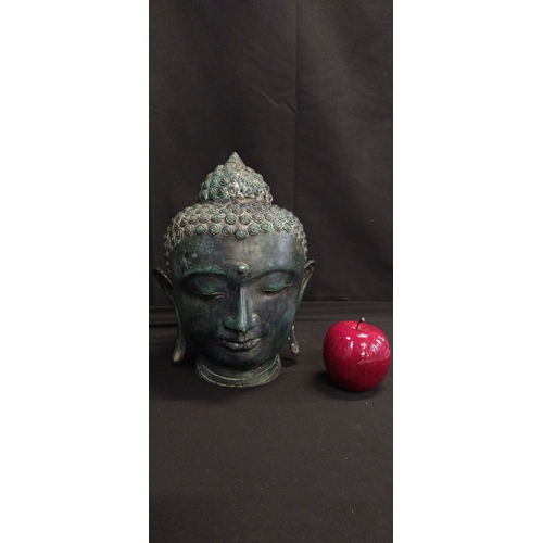 69 - Hollow Copper head of Buddha. Measures approx H 25 x W 20 x D 18.5 cm