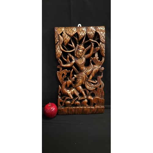 128 - Balinese  dark wood carving panel.featuring a deity and animal. Measures approx H 45.5 x W 25