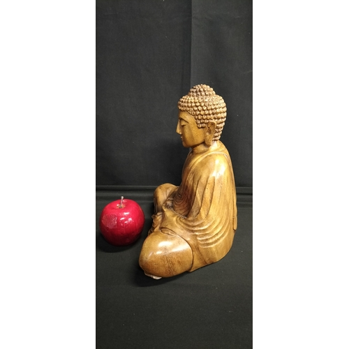 130 - Solid Wood carving of a Buddha seated. Measures approx H 25 x W 23.5 x D 14 cm