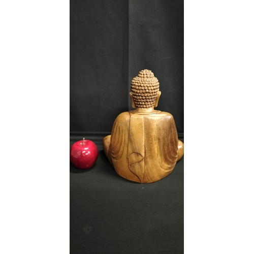 130 - Solid Wood carving of a Buddha seated. Measures approx H 25 x W 23.5 x D 14 cm