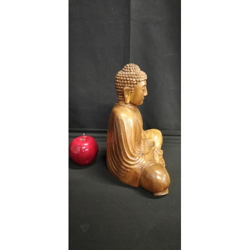 130 - Solid Wood carving of a Buddha seated. Measures approx H 25 x W 23.5 x D 14 cm