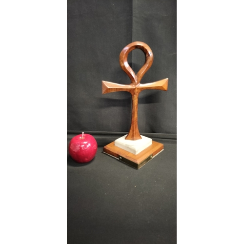 131 - Wooden Ankh Ornament on marble plinth set on wooden base with brass plaque and inscription 