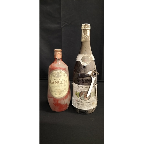 144 - Two unopened bottles of wine. A vintage pot  bottle of imported Lancers Semi-Sweet Rosè. And a bottl... 