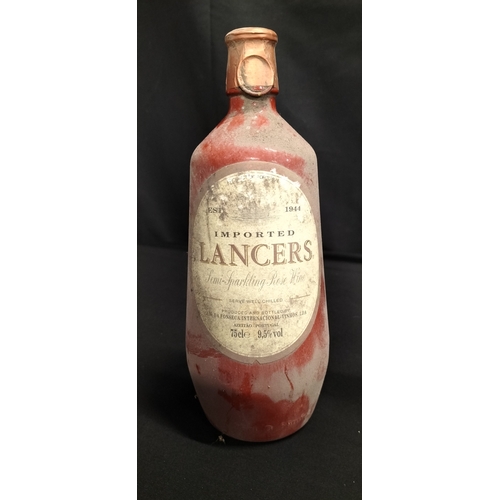 144 - Two unopened bottles of wine. A vintage pot  bottle of imported Lancers Semi-Sweet Rosè. And a bottl... 