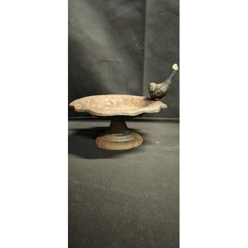 217 - Small decorative cast iron bird bath/ feeder with bird and stand. Measures approx H 14 x W 8 cm