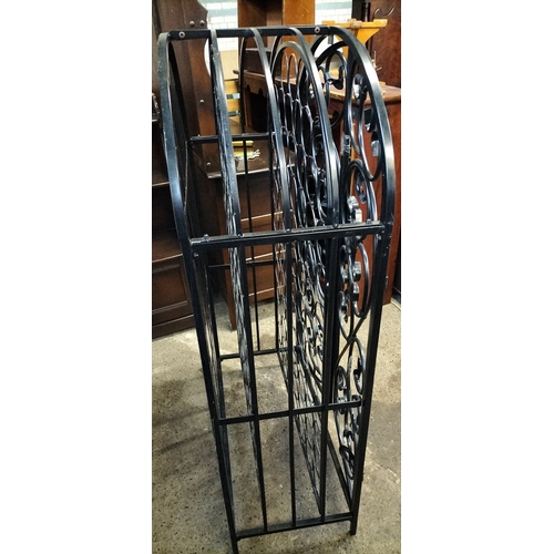 222 - Ornate Black metal gated 79 hole bottle rack. Measures approx H 135 x 78 x D 38 cm. Collection only