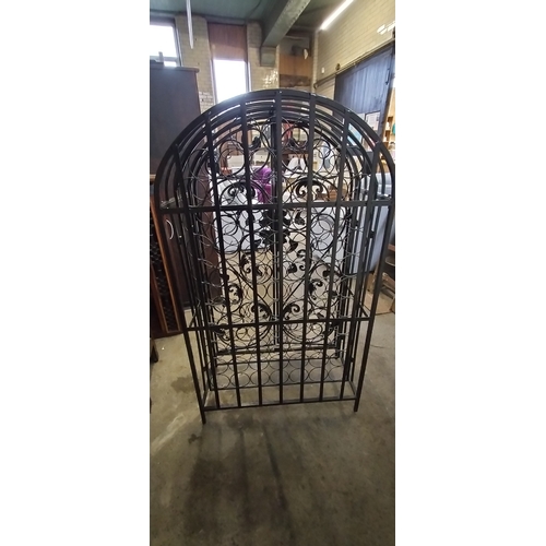 222 - Ornate Black metal gated 79 hole bottle rack. Measures approx H 135 x 78 x D 38 cm. Collection only