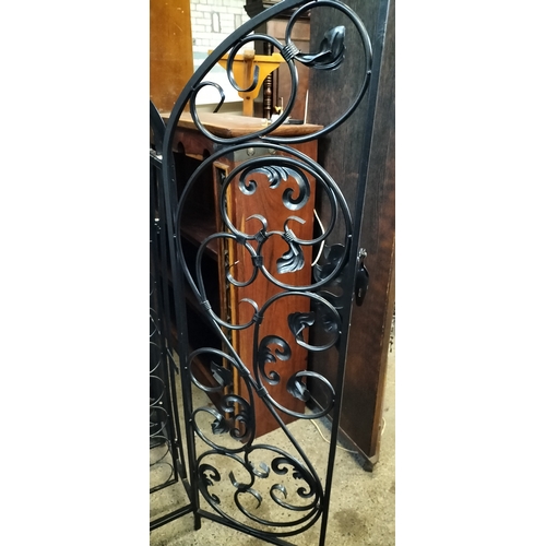 222 - Ornate Black metal gated 79 hole bottle rack. Measures approx H 135 x 78 x D 38 cm. Collection only