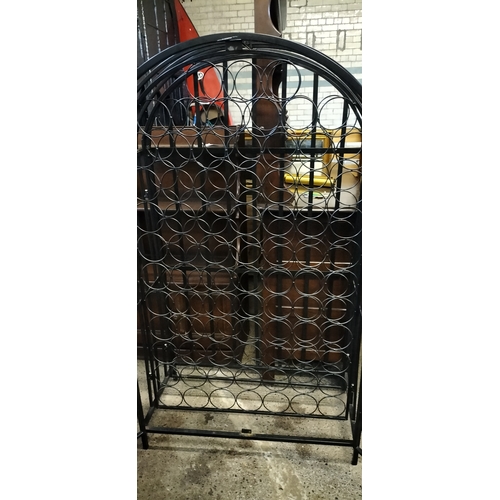 222 - Ornate Black metal gated 79 hole bottle rack. Measures approx H 135 x 78 x D 38 cm. Collection only