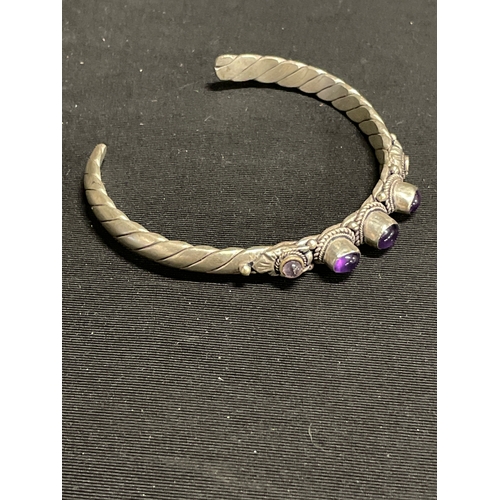 125 - White metal dress bangle with amethyst stones a/f