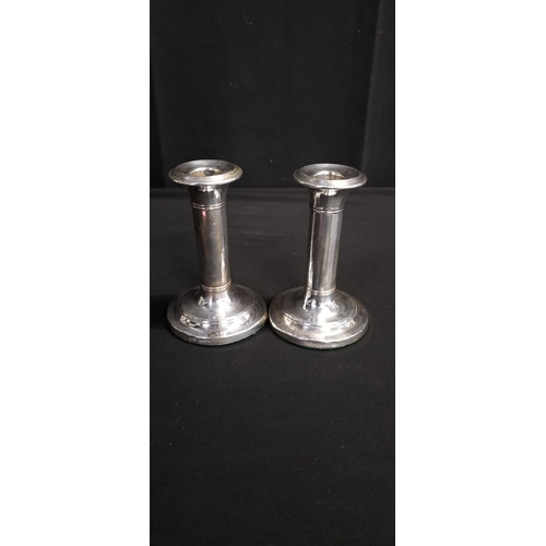 97 - Sterling silver candle holders E.J.C Birmingham date letter K, 1909 Weighted. Approx weight 200g. Me... 