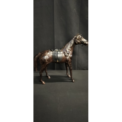 103 - Leather figure of a race horse. Measures approx H 14 x W 51 x D 14.5 cm