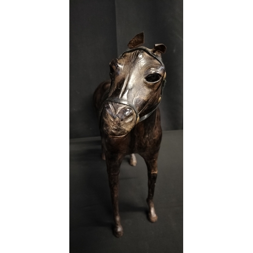 103 - Leather figure of a race horse. Measures approx H 14 x W 51 x D 14.5 cm