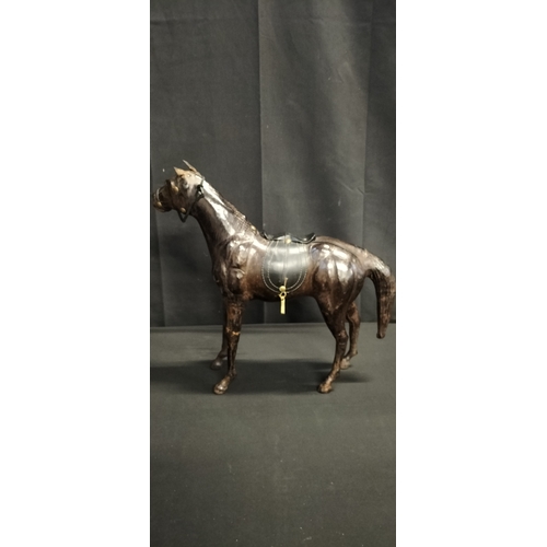 103 - Leather figure of a race horse. Measures approx H 14 x W 51 x D 14.5 cm