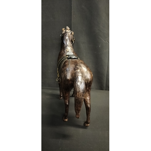 103 - Leather figure of a race horse. Measures approx H 14 x W 51 x D 14.5 cm