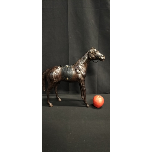 103 - Leather figure of a race horse. Measures approx H 14 x W 51 x D 14.5 cm