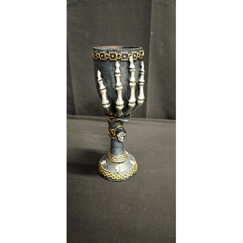 104 - Gothic style polyresin goblet with skeletal hand and crystal