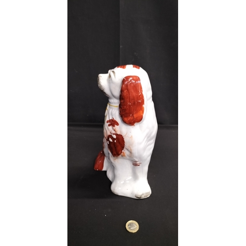 219 - Possible Staffordshire pottery style mantle dog in the form of a king Charles spaniel