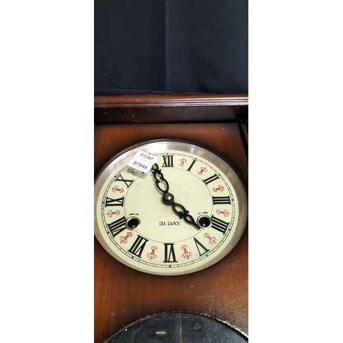 297 - 31 day Mid Century pendulum clock with key and chime. Face has enameling and fluer de lise style des... 