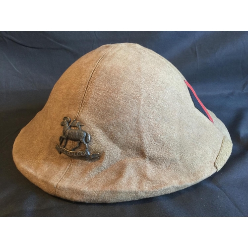 128 - RARE WW1  THE QUEENS BRODIE HELMET COVER WITH BADGE AND FORMATION MARKINGS