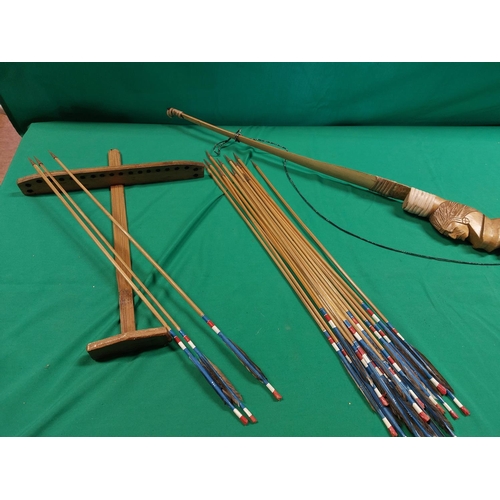 127 - Ornate wooden bow with stand and arrows