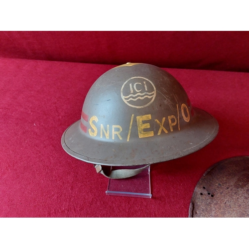 244 - 2 Military helmets one marked with ICI Livery to front.