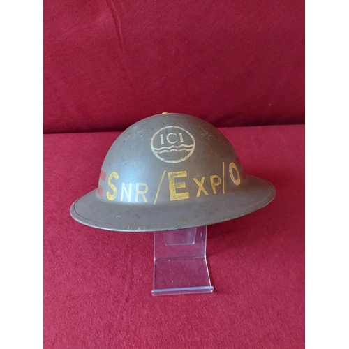 244 - 2 Military helmets one marked with ICI Livery to front.