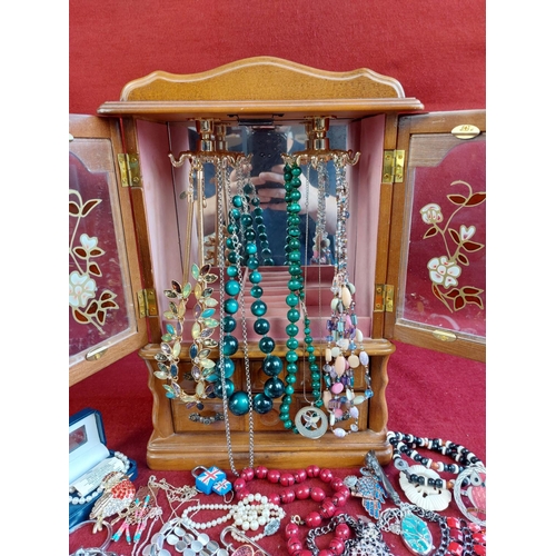 102 - Collection of costume jewellery including wooden cabinet.