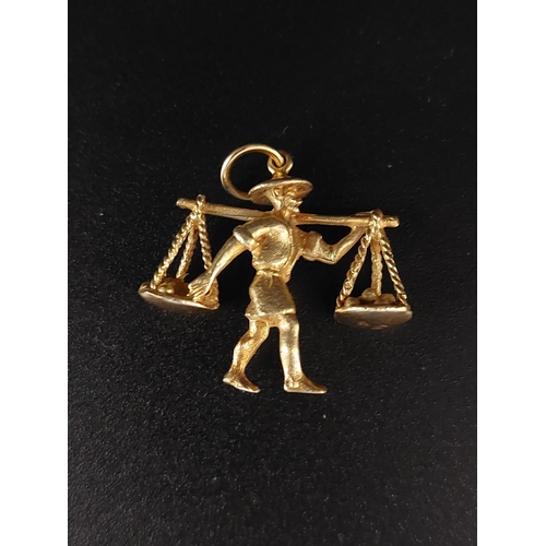 46 - 14ct gold charm / pendant of a market seller. Weight 4 grams