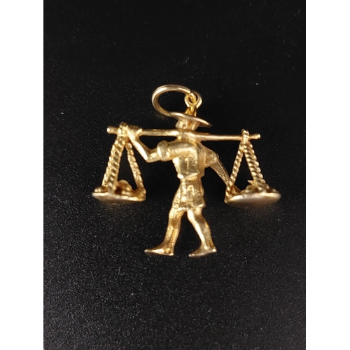 46 - 14ct gold charm / pendant of a market seller. Weight 4 grams