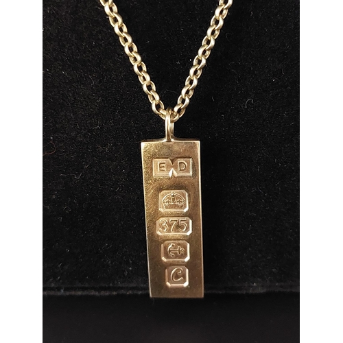 7 - 9ct gold ingot on 9ct gold chain 13.9 grams