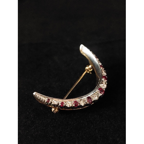 72 - Vintage ruby and diamond crescent brooch set in 9ct gold. 9 rubies, 8 diamonds. Total weight 6.7 gra... 