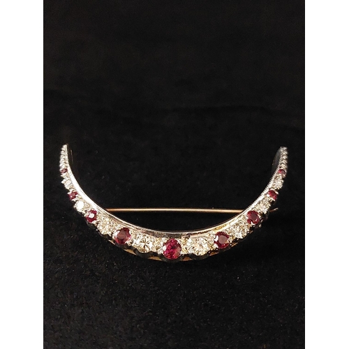 72 - Vintage ruby and diamond crescent brooch set in 9ct gold. 9 rubies, 8 diamonds. Total weight 6.7 gra... 