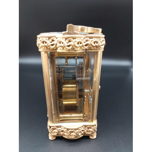 96 - Ornate antique brass carriage clock with enameled front plate. Beveled glass and top platform escape... 