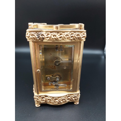 96 - Ornate antique brass carriage clock with enameled front plate. Beveled glass and top platform escape... 