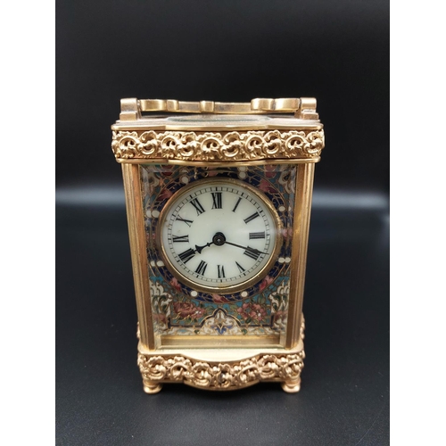 96 - Ornate antique brass carriage clock with enameled front plate. Beveled glass and top platform escape... 