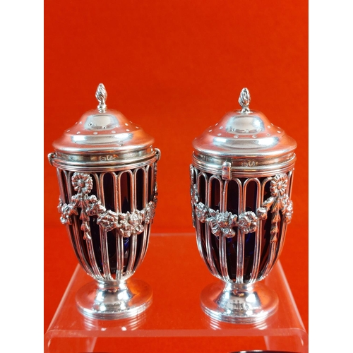 98 - Chester hallmarked 1909 pair of salt cellars sugar casters with swag floral design. Crack to salt ce... 