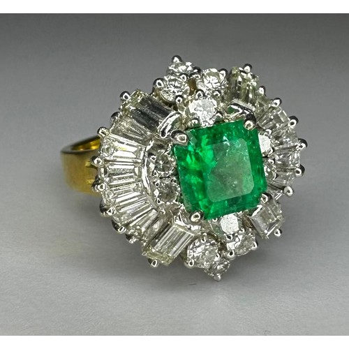 76 - Exquisite Emerald & Diamond dress ring. 1ct emerald cut Emerald surrounded by 12 x.08ct round diamon... 