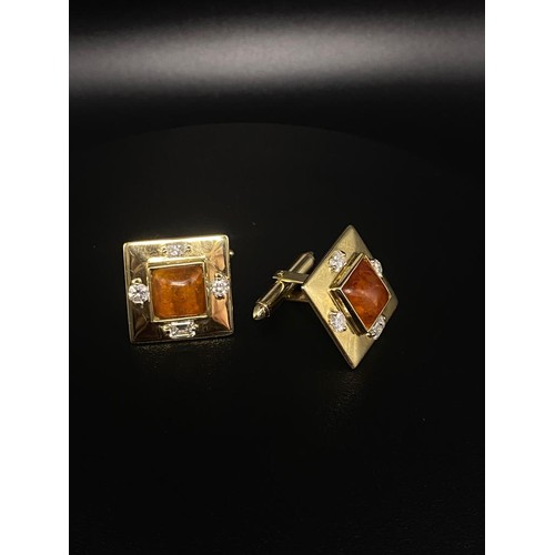 79 - 15 ct cuff links. Square shaped with a centre stone of amber and each having two emerald cut diamond... 