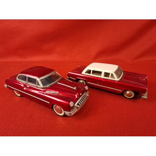 305 - 2 tinplate cars all red one working the other not