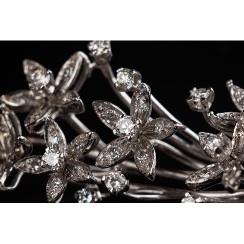 64 - Vintage brooch crafted in 18ct white gold made to resemble a floral branch with leaves. Set with 15 ... 