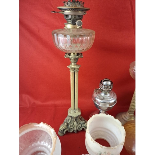 337 - Collection of 6 oil lamps with various glass shades.