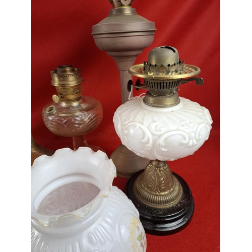 337 - Collection of 6 oil lamps with various glass shades.